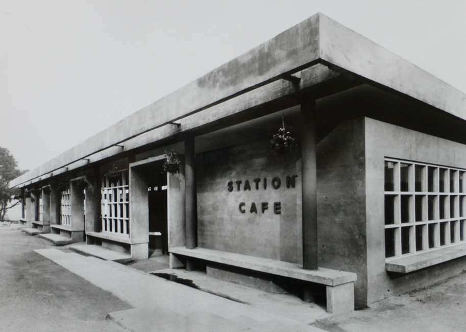 Concrete building with sign that reads 'station cafe'